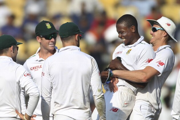 Watched by teammates, South African bowler, Kagiso Rabada, second right, is lifted up by Morne Morkel, after he claimed the wicket of Indian batsman Ravindra Jadeja, on the first day of the third test match between the two countries in Nagpur, India, Wednesday, Nov. 25, 2015.(AP Photo/Rafiq Maqbool)