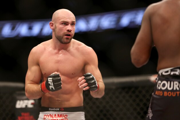 Cathal Pendred, left, in action against Sean Spencer during their fight at UFC Fight Night Boston, Sunday, January 18, 2015 in Boston.  Pendred won via decision. (AP Photo/Gregory Payan)