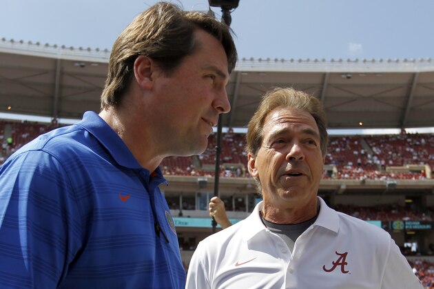 Alabama coach Nick Saban meets with Florida head coach Will Muschamp before the first half of an NCAA college football game against on Saturday, Sept. 20, 2014, in Tuscaloosa, Ala. (AP Photo/Butch Dill)