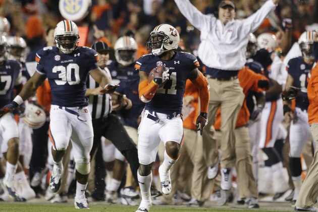 FILE - In this Nov. 30, 2013 file photo, Auburn cornerback Chris Davis (11) returns a field goal attempt 109-yards to score the winning touchdown over Alabama during the second half of an NCAA college football game in Auburn, Ala. Davis's 109-yard return of a missed field goal to beat Alabama was one of the Iron Bowl's and the season's most memorable plays. (AP Photo/Dave Martin, File)