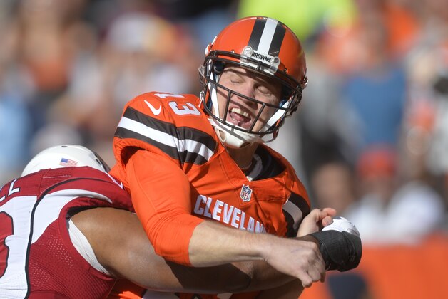 Cleveland Browns quarterback Josh McCown, right, reacts after being hit after throwing a pass during an NFL football game against the Arizona Cardinals Sunday, Nov. 1, 2015, in Cleveland. Arizona won 34-20. (AP Photo/David Richard)