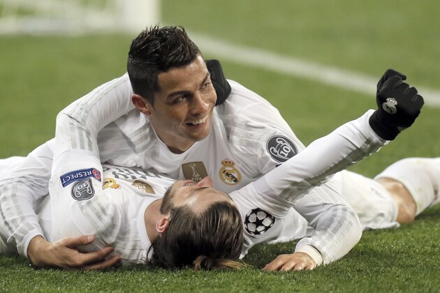 Real Madrid's Cristiano Ronaldo, top, celebrate his side's 4th goal with teammate,   Gareth Bale, during the Champions League Group A soccer match between FC Shakhtar and Real Madrid at Arena Lviv stadium in Lviv, Western Ukraine, Wednesday, Nov. 25, 2015. (AP Photo/Efrem Lukatsky)