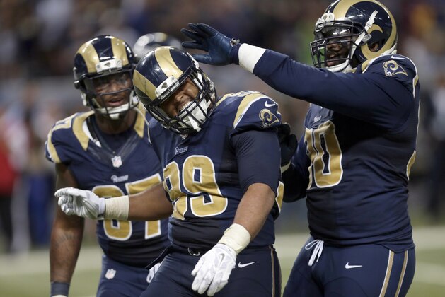 St. Louis Rams defensive tackle Aaron Donald, center, is congratulated by teammates defensive tackle Michael Brockers, right, and defensive end Eugene Sims after sacking Seattle Seahawks quarterback Russell Wilson for a 4-yard loss during the third quarter of an NFL football game Sunday, Sept. 13, 2015, in St. Louis. (AP Photo/Tom Gannam)