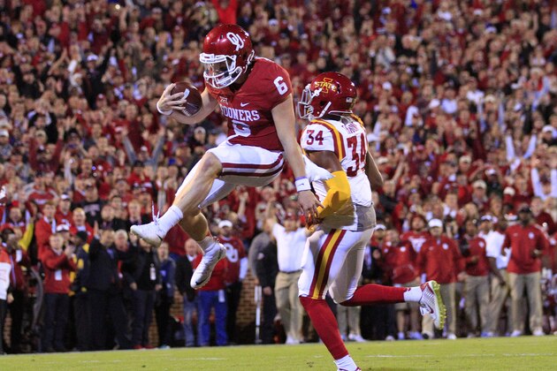 Oklahoma quarterback Baker Mayfield (6) leaps in for a touchdown against Iowa State during the first quarter of an NCAA college football game in Norman, Okla., on Saturday, Nov. 7, 2015. (AP Photo/Alonzo Adams)
