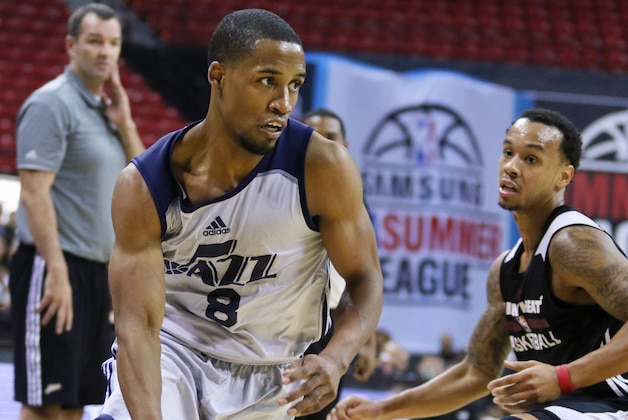 Utah Jazz's Bryce Cotton, left, drives the ball around Miami Heat's Shabazz Napier during the second half of an NBA summer league basketball game Saturday, July 11, 2015, in Las Vegas. The Heat won 82-79. (AP Photo/Ronda Churchill)