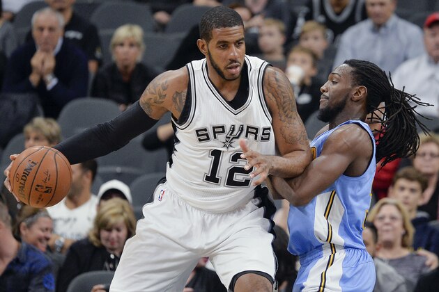 San Antonio Spurs forward LaMarcus Aldridge (12) drives around Denver Nuggets forward Kenneth Faried during the first half of an NBA basketball game, Wednesday, Nov. 18, 2015, in San Antonio. (AP Photo/Darren Abate)