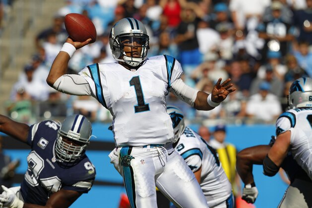 Carolina Panthers quarterback Cam Newton (1) works against the Dallas Cowboys during the second half of an NFL football game, Sunday, Oct. 21, 2012, in Charlotte, N.C. (AP Photo/Chuck Burton)