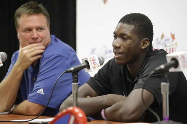 Cheick Diallo speaks with reporters while Kansas coach Bill Self listens during a news conference after Kansas defeated Vanderbilt 70-63 in an NCAA college basketball game in the Maui Invitational on Wednesday, Nov. 25, 2015, in Lahaina, Hawaii. The NCAA will allow Diallo to begin playing for No. 5 Kansas beginning next week, ending a months-long investigation into the prospect's education and background. (AP Photo/Rick Bowmer)