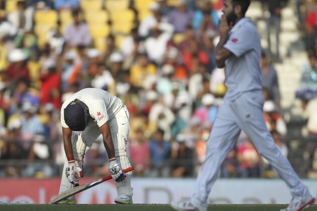 Indian batsman Amit Mishra, center, reacts after being bowled out by South African bowler Imran Tahir, right, on the second day of the third cricket test match between the two countries in Nagpur, India, Thursday, Nov. 26, 2015. Mishra was Tahir's fifth scalp of the innings. (AP Photo/Rafiq Maqbool)