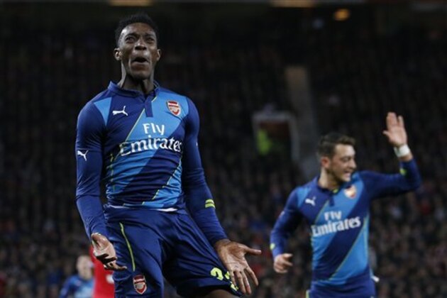 Arsenal's Danny Welbeck  celebrates after scoring his side second goal during the English FA Cup quarterfinal soccer match between Manchester United and Arsenal at Old Trafford Stadium, Manchester, England, Monday, March 9, 2015. (AP Photo/Jon Super)
