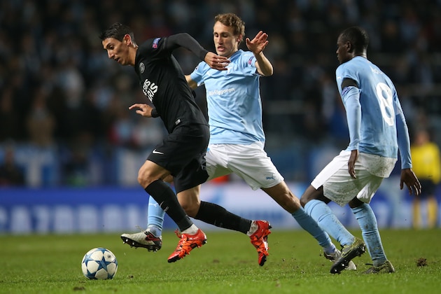 Paris SG's Angel Di Maria, left, is challenged by Malmo FF's Magnus Wolff Eikrem, center, and Enoch Kofi Adu during the Champions League Group A soccer match between Malmo FF and Paris Saint-Germain FC at Malmo New Stadium in Malmo, Sweden, Wednesday Nov. 25, 2015. (Andreas Hillergren/TT via AP) SWEDEN OUT