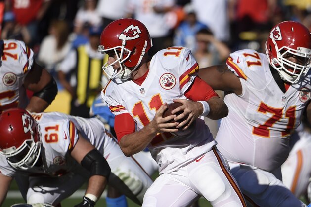 Kansas City Chiefs quarterback Alex Smith gets away from San Diego Chargers outside linebacker Melvin Ingram during the first half of an NFL football game Sunday, Nov. 22, 2015, in San Diego. (AP Photo/Denis Poroy)