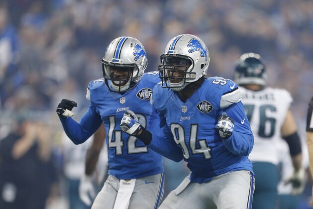 Detroit Lions strong safety Isa Abdul-Quddus (42) and efensive end Ezekiel Ansah (94) celebrate after a play during the second half of an NFL football game against the Philadelphia Eagles, Thursday, Nov. 26, 2015, in Detroit. (AP Photo/Rick Osentoski)