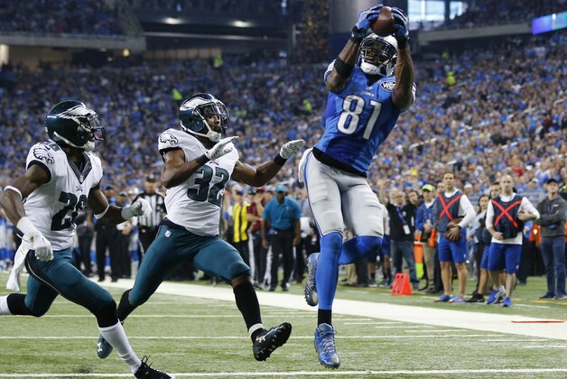Detroit Lions wide receiver Calvin Johnson (81) catches a 25-yard pass for a touchdown defended by Philadelphia Eagles strong safety Walter Thurmond (26) and cornerback Eric Rowe (32) during the first half of an NFL football game, Thursday, Nov. 26, 2015, in Detroit. (AP Photo/Rick Osentoski)