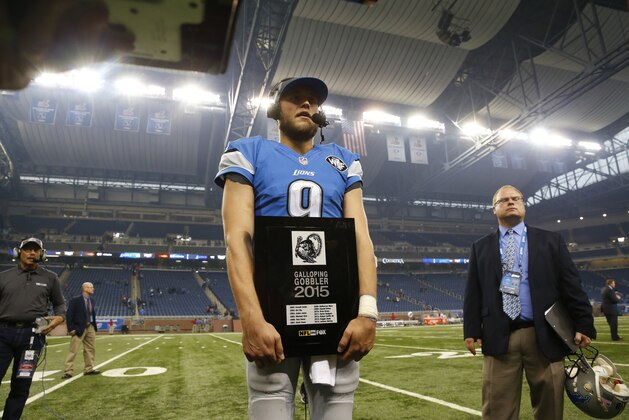 Detroit Lions quarterback Matthew Stafford poses with the Galloping Gobbler award after an NFL football game against the Philadelphia Eagles, Thursday, Nov. 26, 2015, in Detroit. The Lions defeated the Eagles 45-14. (AP Photo/Paul Sancya)