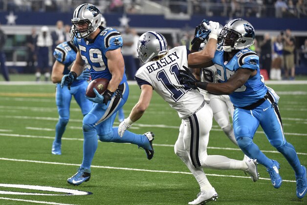 Carolina Panthers middle linebacker Luke Kuechly (59) gets help from cornerback Bene' Benwikere (25) defending against Dallas Cowboys wide receiver Cole Beasley (11) after intercepting a pass from the Cowboys' Tony Romo that he ran back for a touchdown in the first half of an NFL football game, Thursday, Nov. 26, 2015, in Arlington, Texas. (AP Photo/Michael Ainsworth)