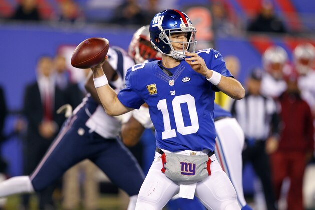 New York Giants quarterback Eli Manning (10) looks to pass against the New England Patriots during the second half of an NFL football game Sunday Nov. 15, 2015, in East Rutherford, N.J. (AP Photo/Gary Hershorn)