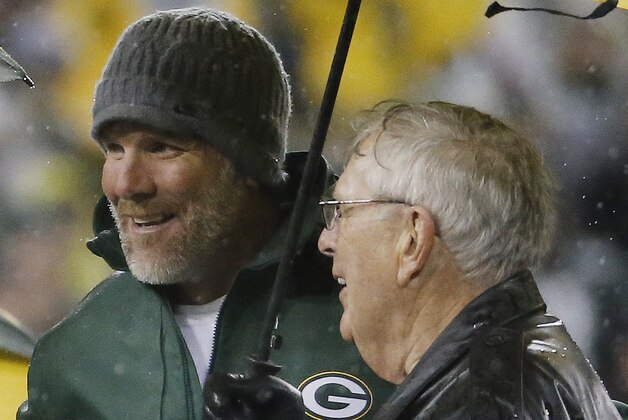 Brett Favre stands with former general manager Ron Wolf during a ceremony at halftime of an NFL football game between the Green Bay Packers and Chicago Bears Thursday, Nov. 26, 2015, in Green Bay, Wis. Favre’s retired No. 4 and name were unveiled inside Lambeau Field during the ceremony. (AP Photo/Morry Gash)