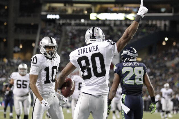Oakland Raiders wide receiver Rod Streater (80) celebrates with wide receiver Seth Roberts, left, after Streater caught a pass for a touchdown against the Seattle Seahawks in the second half of a preseason NFL football game, Thursday, Sept. 3, 2015, in Seattle. (AP Photo/Stephen Brashear)