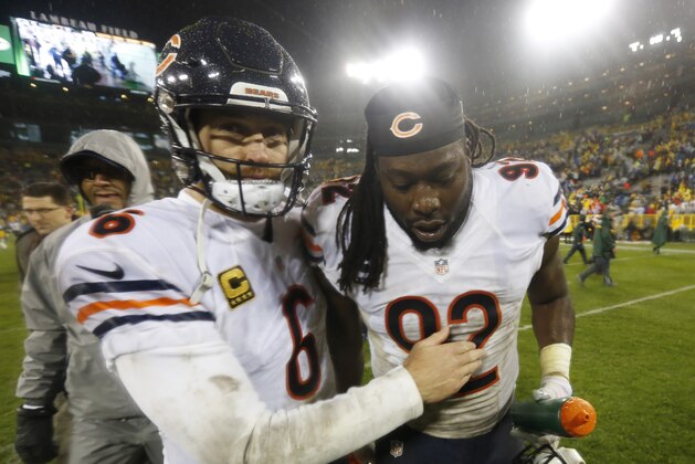 Chicago Bears' Jay Cutler (6) and Pernell McPhee (92) celebrate after an NFL football game against the Green Bay Packers Thursday, Nov. 26, 2015, in Green Bay, Wis. The Bears won 17-13. (AP Photo/Mike Roemer)