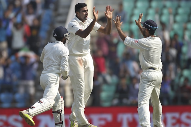 Indian spinner Ravichandran Ashwin, center, celebrates with teammates Ajinkya Rahane, right, and Wriddhiman Saha, as he takes the wicket of South African batsman AB de Villiers, on the third day of the third cricket test match between the two countries in Nagpur, India, Friday, Nov. 27, 2015. (AP Photo/Rafiq Maqbool)