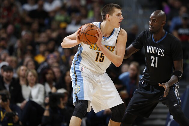 Denver Nuggets center Nikola Jokic (15), left, is covered by Minnesota Timberwolves forward Kevin Garnett (21) during the second half of an NBA basketball game Friday, Oct. 30, 2015, in Denver. Minnesota won 95-78. (AP Photo/David Zalubowski)