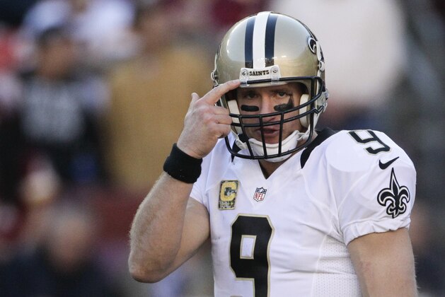 New Orleans Saints quarterback Drew Brees (9) points toward his helmet during the first half of an NFL football game against the Washington Redskins in Landover, Md., Sunday, Nov. 15, 2015. (AP Photo/Mark Tenally)