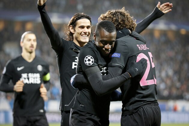 Paris Saint-Germain's Adrien Rabiot, right, celebrates scoring the opening goal with teammates Blaise Matuidi, center, and Edinson Cavan during the Champions League Group A soccer match between Malmo FF and Paris Saint-Germain FC at Malmo New Stadium in Malmo, Sweden, Wednesday, Nov. 25, 2015. (Andreas Hillergren/TT News Agency via AP)    SWEDEN OUT