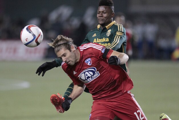 FC Dallas midfielder Ryan Hollingshead (12) battles Portland Timbers midfielder/forward Dairon Asprilla during the first half of the first leg of the MLS soccer Western Conference championship in Portland, Ore., Sunday, Nov. 22, 2015. (AP Photo/Steve Dipaola)