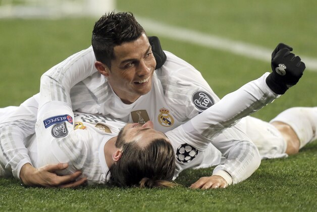 Real Madrid's Cristiano Ronaldo, top, celebrate his side's 4th goal with teammate,   Gareth Bale, during the Champions League Group A soccer match between FC Shakhtar and Real Madrid at Arena Lviv stadium in Lviv, Western Ukraine, Wednesday, Nov. 25, 2015. (AP Photo/Efrem Lukatsky)