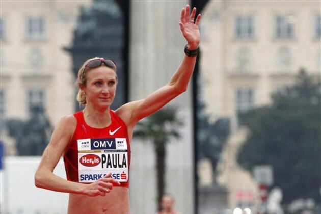FILE - In this April 15, 2012, file photo, British long-distance runner and marathon world record-holder Paula Radcliffe reacts after crossing the finish line at the Vienna city half marathon, in downtown Vienna, Austria. Radcliffe.  Radcliffe has been ruled out of the Olympic marathon because of a foot injury that flared up during training over the past month. UK Athletics confirmed Sunday, July 29, 2012, that she would miss the London Olympics for medical reasons. (AP Photo/Ronald Zak, File)