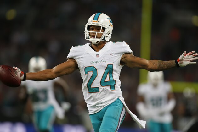 Miami Dolphins' Cortland Finnegan celebrates after recovering a fumbled snap for a touchdown during the second half of an NFL football game against the Oakland Raiders, Sunday, Sept. 28, 2014, at Wembley Stadium in London. (AP Photo/Lefteris Pitarakis)
