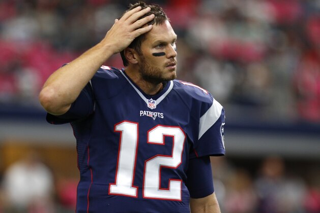 New England Patriots' Tom Brady (12) walks across the field during team warm ups before an NFL football game against the Dallas Cowboys, Sunday, Oct. 11, 2015, in Arlington, Texas. (AP Photo/Roger Steinman)