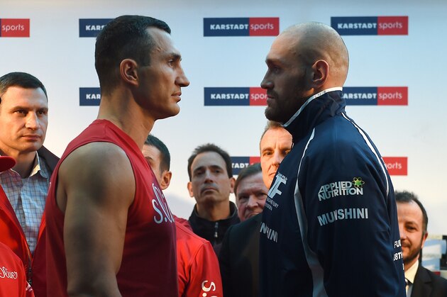 Ukrainian Heavyweight World Champion Wladimir Klitschko (2nd L) and his challenger Britain's Tyson Fury (R) pose for a face-off during an official weigh-in in Essen, western Germany on November 27, 2015. World heavyweight champion Klitschko will defend his IBF, WBA and IBO titles against British challenger Tyson Fury in Duesseldorf on November 28, 2015. AFP PHOTO / PATRIK STOLLARZ / AFP / PATRIK STOLLARZ        (Photo credit should read PATRIK STOLLARZ/AFP/Getty Images)