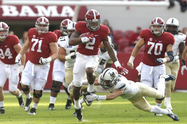 Alabama running back Derrick Henry (2) carries the ball for a first down as he is tripped up by Charleston Southern linebacker Zack Johnson (22) during the first half of an NCAA football game, Saturday, Nov. 21, 2015, in Tuscaloosa, Ala. (AP Photo/Butch Dill)
