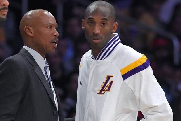 Los Angeles Lakers guard Kobe Bryant, right, talks with head coach Byron Scott during the first half of an NBA basketball game against the Golden State Warriors, Sunday, Nov. 16, 2014, in Los Angeles. (AP Photo/Mark J. Terrill)