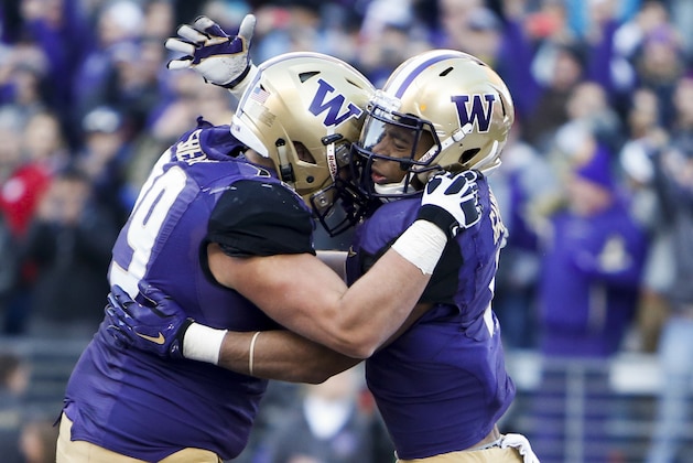 Nov 27, 2015; Seattle, WA, USA; Washington Huskies offensive lineman Coleman Shelton (79) congratulates fullback Myles Gaskin (9) after Gaskin scored a touchdown against the Washington State Cougars during the second quarter at Husky Stadium. Mandatory Credit: Jennifer Buchanan-USA TODAY Sports