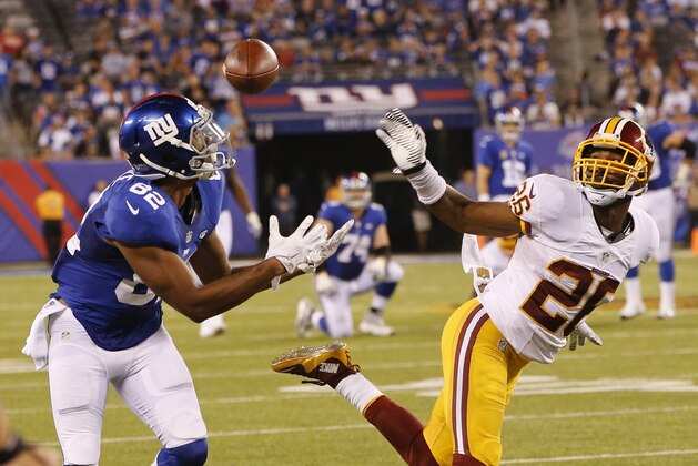 New York Giants wide receiver Rueben Randle (82) catches a pass in front of Washington Redskins' Bashaud Breeland (26) during the second half an NFL football game Thursday, Sept. 24, 2015, in East Rutherford, N.J. (AP Photo/Kathy Willens)