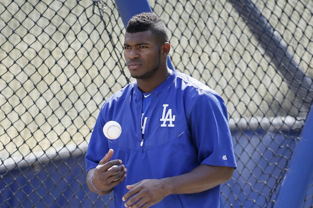 Los Angeles Dodgers' Yasiel Puig tosses a ball during practice for the upcoming NLDS playoff baseball series against the New York Mets, Tuesday, Oct. 6, 2015, in Los Angeles. Their NLDS best of five playoff series begins Friday, Oct. 9, at Dodger Stadium. (AP Photo/Danny Moloshok)