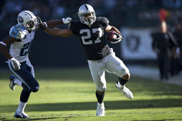 OAKLAND, CA - NOVEMBER 24: Rashad Jennings #27 of the Oakland Raiders rushes up field past Alterraun Verner #20 of the Tennessee Titans during the second quarter at O.co Coliseum on November 24, 2013 in Oakland, California. The Tennessee Titans defeated the Oakland Raiders 23-19. (Photo by Jason O. Watson/Getty Images)