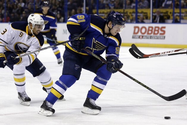 St. Louis Blues' Vladimir Tarasenko, of Russia, controls the puck as Buffalo Sabres' Evander Kane, left, defends during the second period of an NHL hockey game Thursday, Nov. 19, 2015, in St. Louis. (AP Photo/Jeff Roberson)