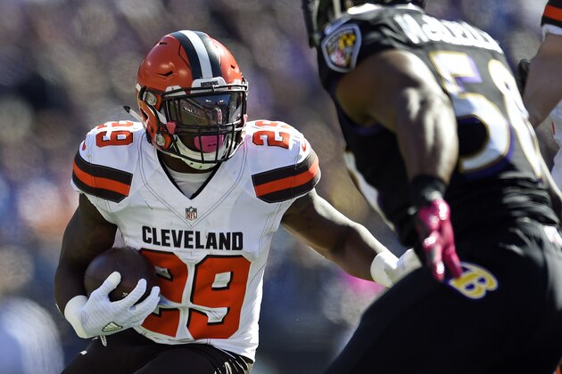 Cleveland Browns running back Duke Johnson, left, rushes against Baltimore Ravens outside linebacker Albert McClellan in the first half of an NFL football game, Sunday, Oct. 11, 2015, in Baltimore. (AP Photo/Gail Burton)