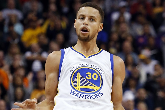 Golden State Warriors guard Stephen Curry reacts after scoring a three-point basket in the first quarter during an NBA basketball game against the Phoenix Suns, Friday, Nov. 27, 2015, in Phoenix. (AP Photo/Rick Scuteri)
