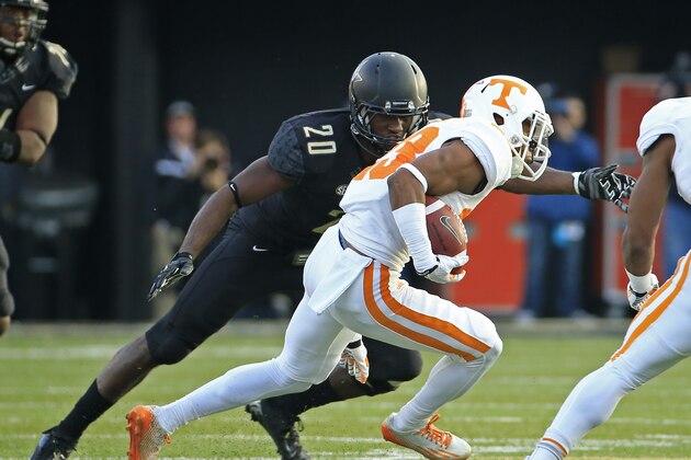 Tennessee's Cameron Sutton (23) gets past Vanderbilt defensive back Oren Burks (20) while returning a punt 76 yards for a touchdown in the first quarter of an NCAA college football game Saturday, Nov. 29, 2014, in Nashville, Tenn. (AP Photo/Mark Humphrey)