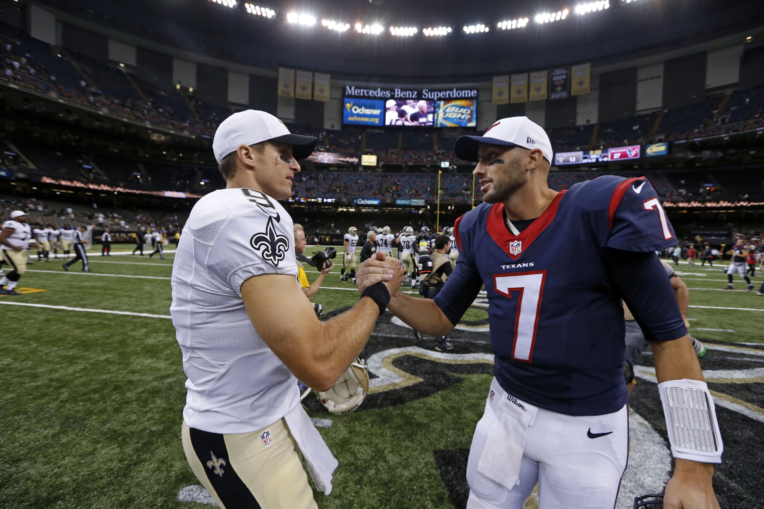 New Orleans Saints quarterback Drew Brees (9) greets Houston Texans quarterback Brian Hoyer (7) after a preseason NFL football game in New Orleans, Sunday, Aug. 30, 2015. (AP Photo/Jonathan Bachman)