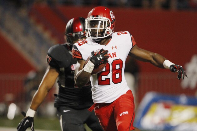 Utah running back Joe Williams (28) carries past Fresno State's Kyrie Wilson during the first half of an NCAA college football game in Fresno, Calif., Saturday, Sept. 19, 2015. (AP Photo/Gary Kazanjian)