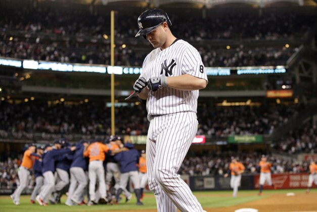 Oct 6, 2015; Bronx, NY, USA; New York Yankees catcher Brian McCann (34) walks off as the Houston Astros celebrate winning the American League Wild Card playoff baseball game at Yankee Stadium. Houston won 3-0. Mandatory Credit: Adam Hunger-USA TODAY Sports