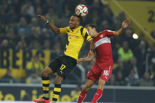 Dortmund's Pierre-Emerick Aubameyang from Gabun, left and Stuttgart's Florian Klein from Austria challenge for the ball during the German first division Bundesliga soccer match between BvB Borussia Dortmund  and VfB Stuttgart in Dortmund, Germany, Wednesday, Sept. 24, 2014. (AP Photo/Frank Augstein)