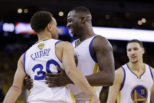 Golden State Warriors guard Stephen Curry (30) celebrates with forward Draymond Green, center, and guard Klay Thompson (11) after Game 5 of basketball's NBA Finals against the Cleveland Cavaliers in Oakland, Calif., Sunday, June 14, 2015. The Warriors won 104-91. (AP Photo/Ben Margot)