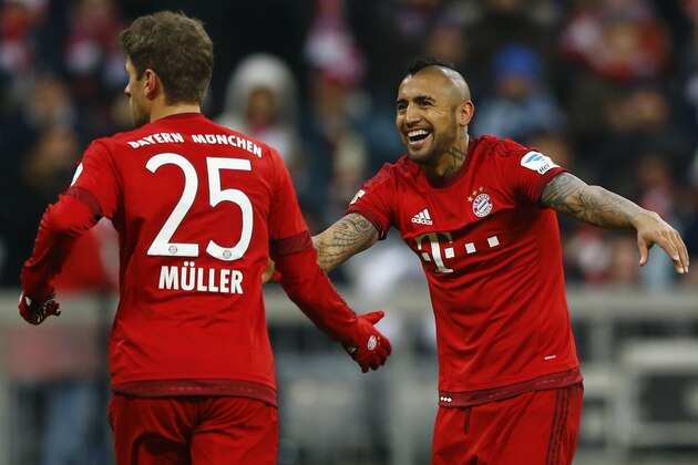 Bayern's Arturo Vidal, right, laughs besides teammate Thomas Mueller during the German Bundesliga soccer match between FC Bayern Munich and Hertha BSC Berlin at the Allianz Arena stadium in Munich, Germany, Saturday, Nov. 28, 2015. (AP Photo/Matthias Schrader)